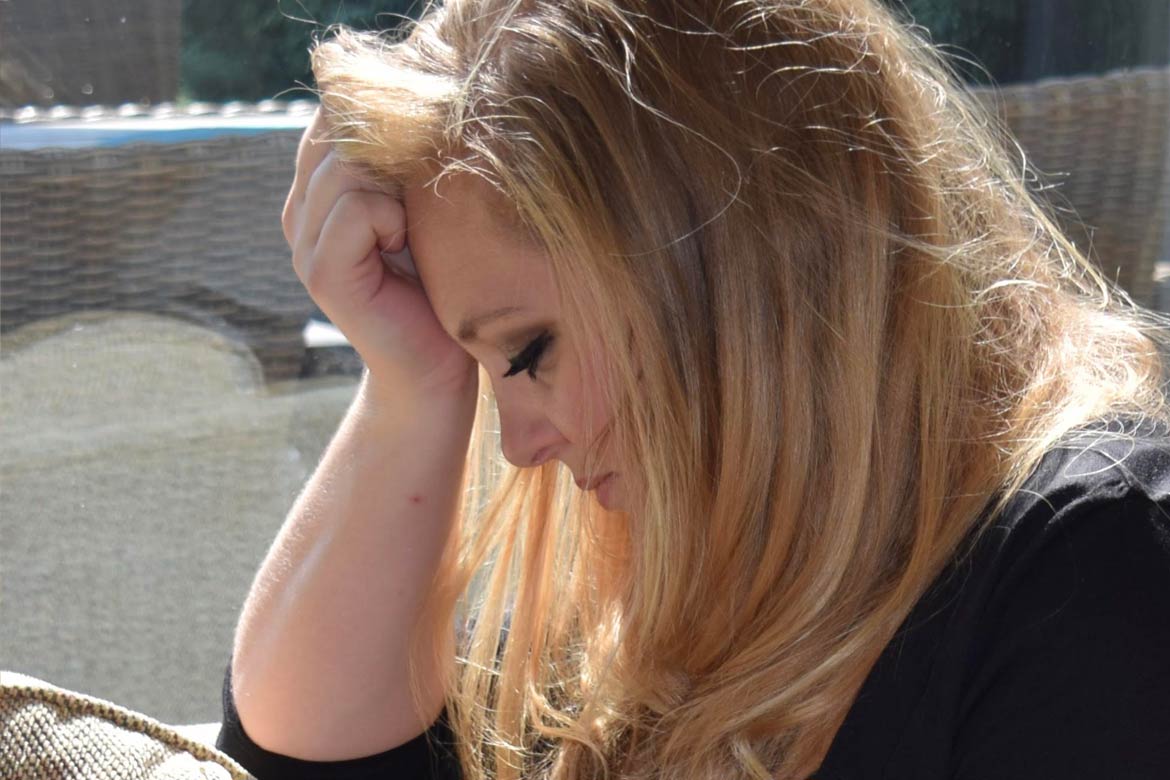 woman with her head in her hand